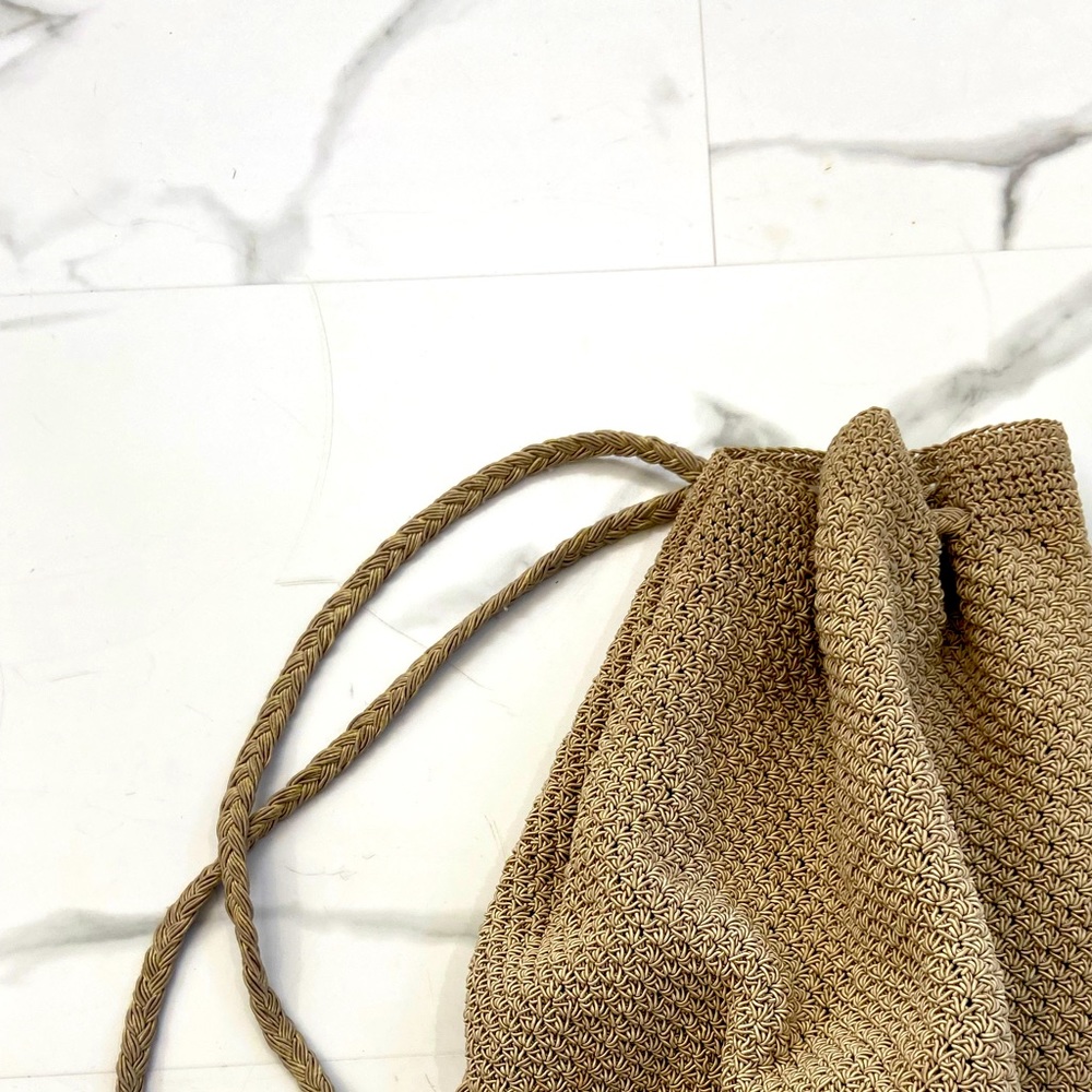 Woven style backpack. Medium size & tan color. My favorite go to bag. 11 inches